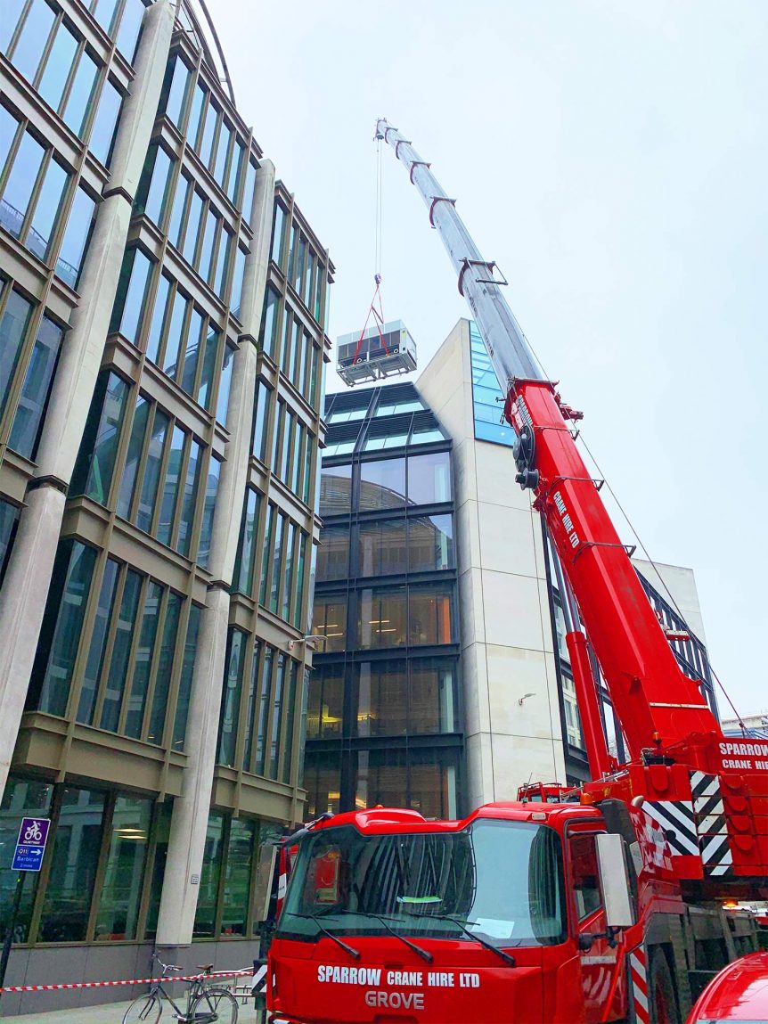 Grove GMK5250L lifting an air con unit on to a building in Gresham St. City of London