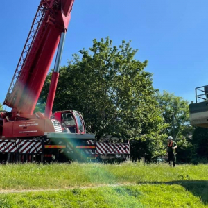 Crane lifting boat into water Bath