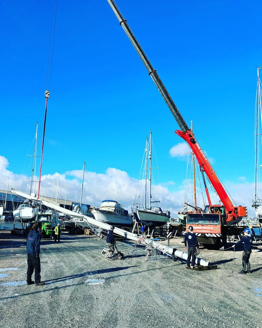 crane lifting yacht mast