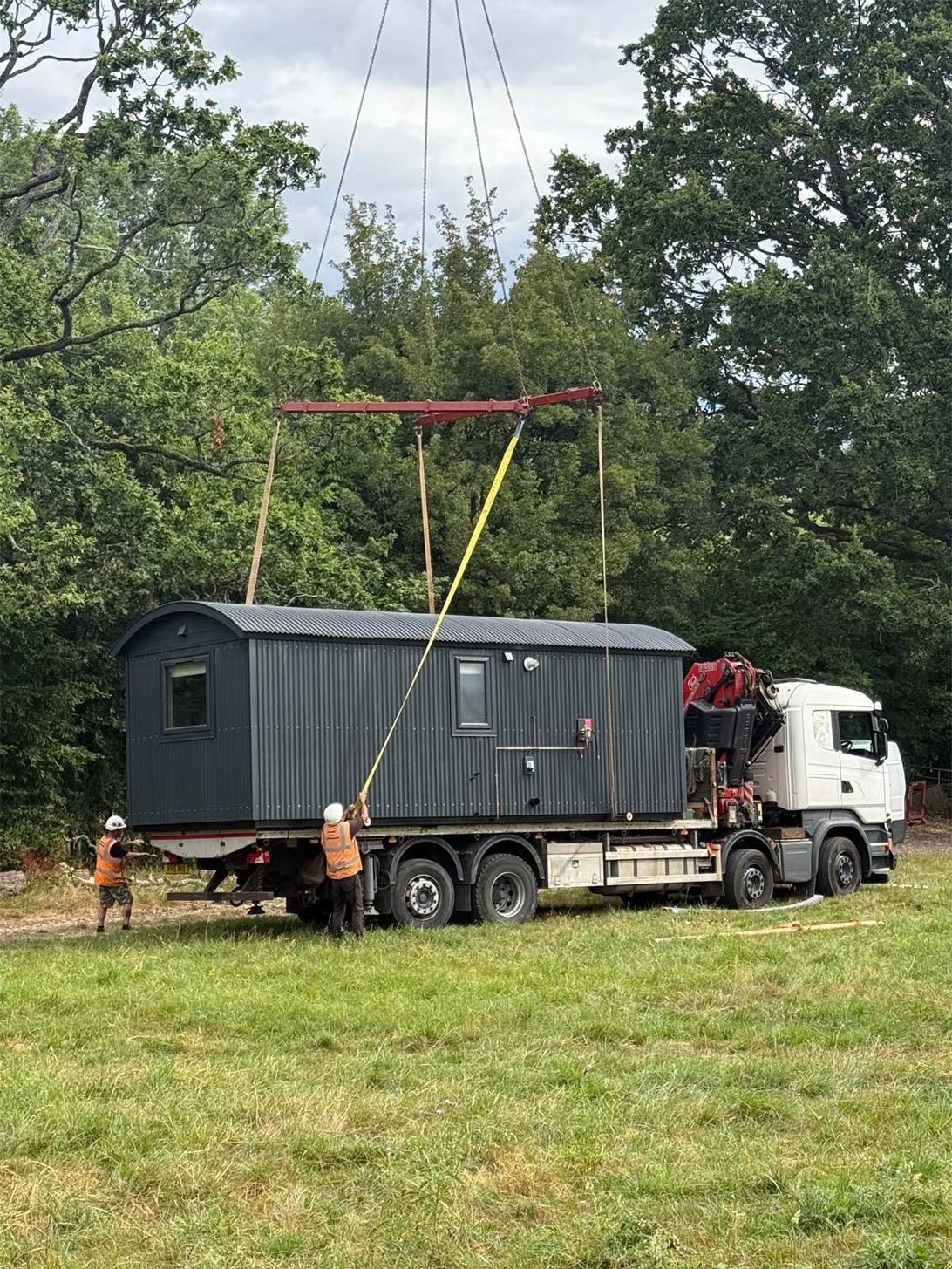 Liebherr LTM1060-3.1 preparing to lift a bespoke shepherd hut from a delivery vehicle for installation at a rural site