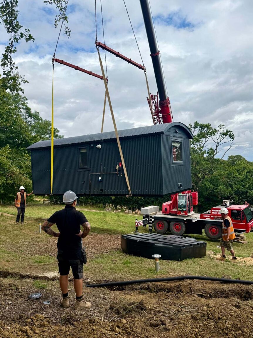 Sparrow Crane Hire installing a Greendown Shepherd Hut at a rural site using a Liebherr LTM1060-3.1 mobile crane
