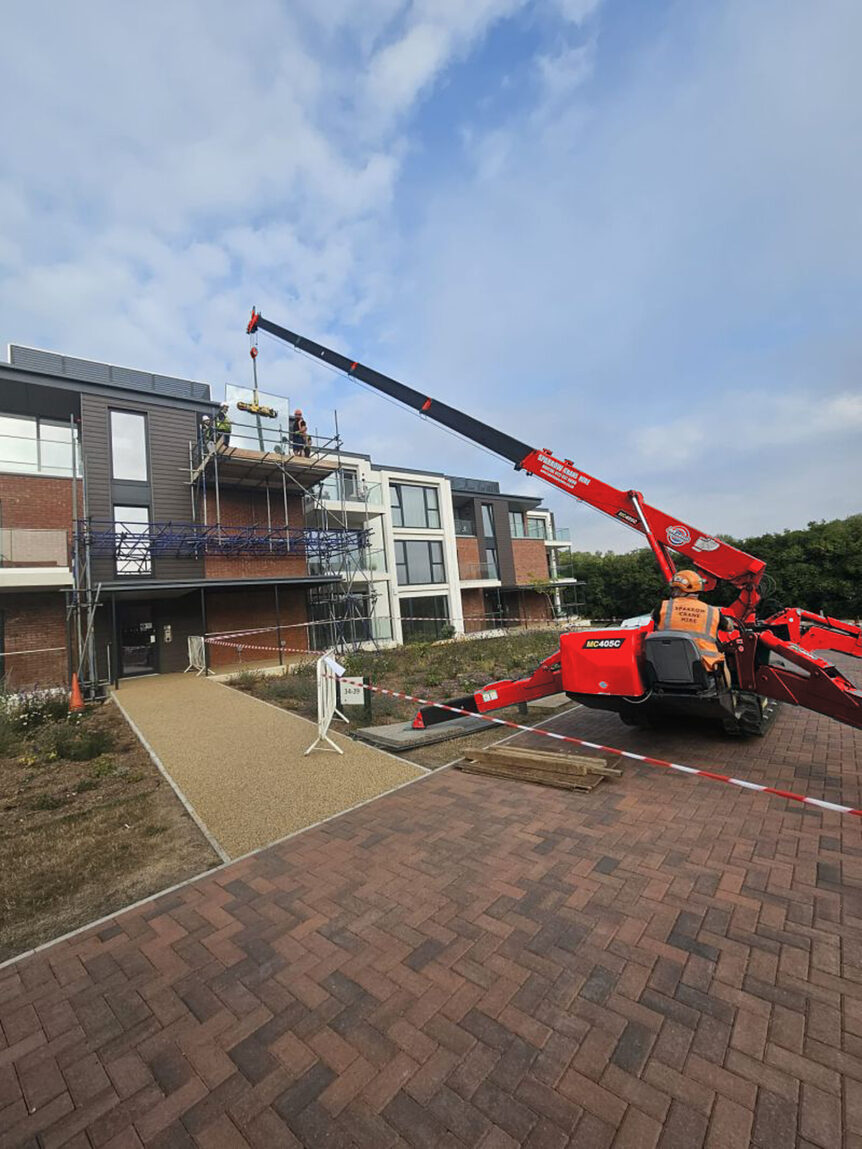 Glass panel being lifted towards the balcony