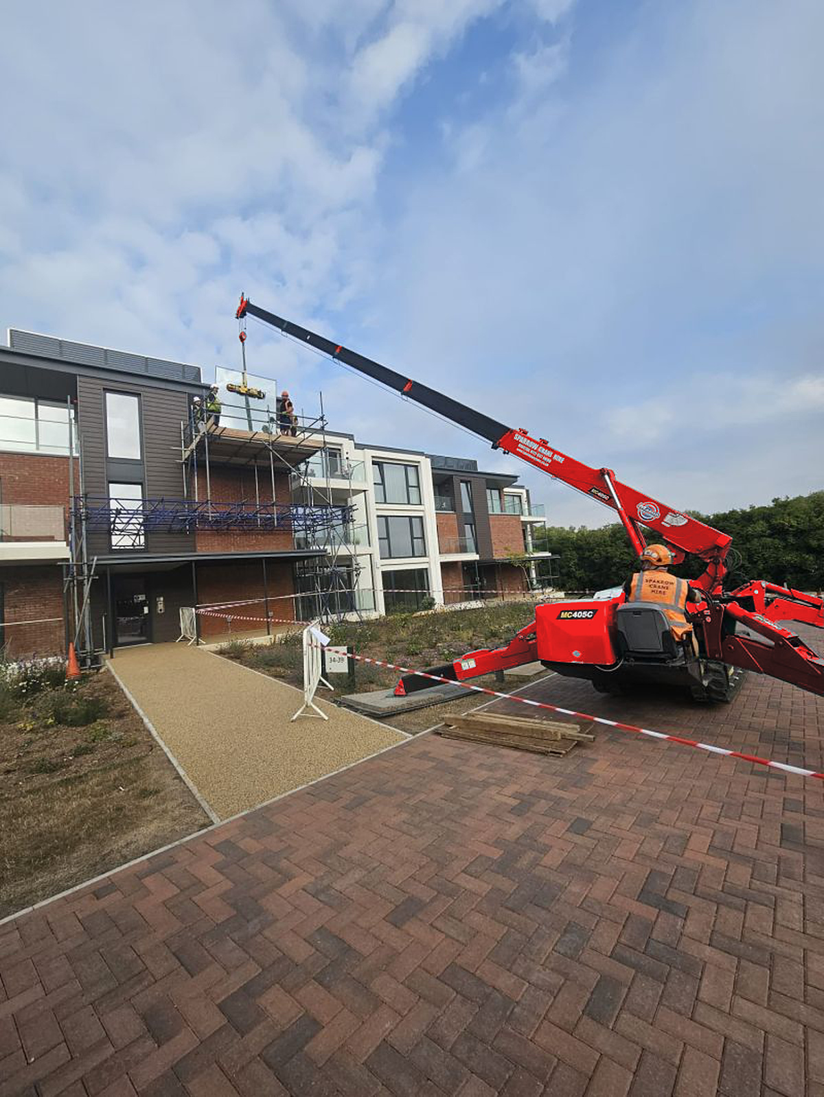 Glass panel being lifted towards the balcony